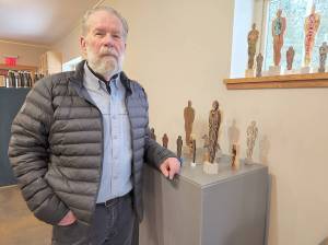John Blackie, with some of his Primitive Figure creations at the Christina Lake Arts and Artisans Society gallery and space. His show, featuring a series of human-form carvings and castings, is running until Feb. 28. Photo/Karen McKinley